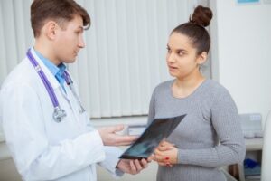 A male doctor is speaking to his female patient about the results of her barium X-ray The patient asked the doctor What are the common conditions that affect the esophagus