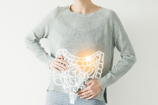 Intestine visualisation on woman body she is holding stomach